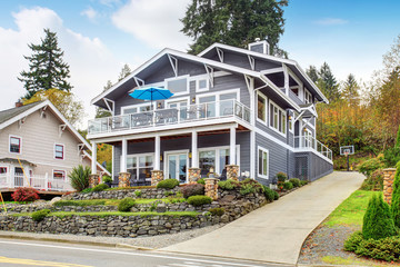 Large gray modern house and garage.
