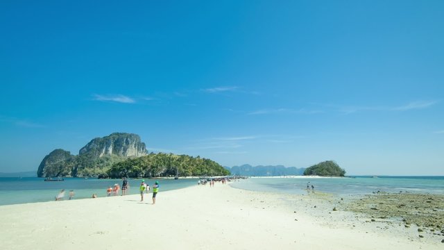 White sand beach in Thailand, Krabi, Tub island. Rising tide over sandy isthmus