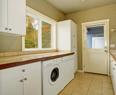 Laundry room with tile counters and sink.