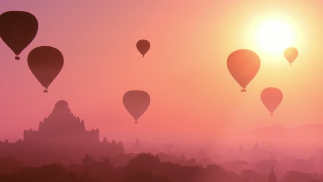 Myanmar Bagan at sunset with flying air balloons over ancient Dhammayangyi 