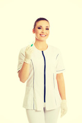 Female dentist holding a syringe