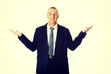 Businessman with open hands in undecided gesture