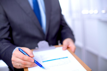 File folders, standing on shelves in the background