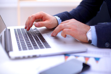 Man's hands typing on laptop. Internet surfing