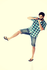 Young casual man kicking.
