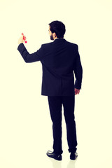 Intelligent man writing with big pencil.