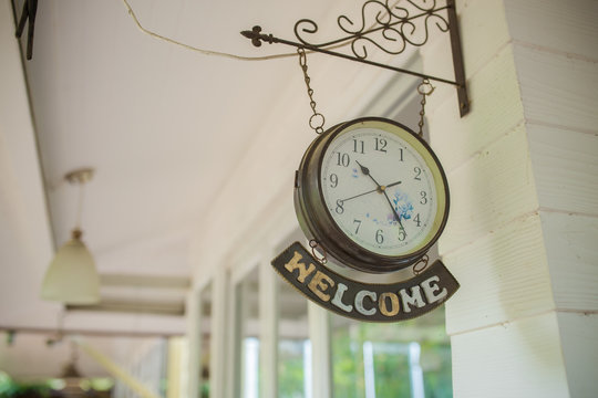 welcome sign and wall clock