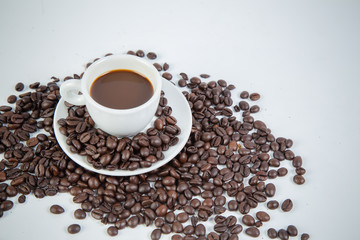 Coffee cup and beans on a white background.