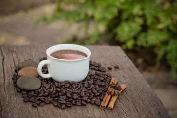 Coffee cup and coffee bean on a wooden table