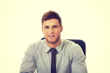 Businessman sitting by a desk in the office.