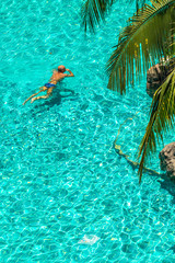 Relaxing in swimming pool./ Man swimming in the crystal-clear pool.
