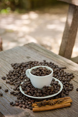 Coffee cup and coffee bean on a wooden table