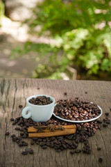 Coffee cup and coffee bean on a wooden table