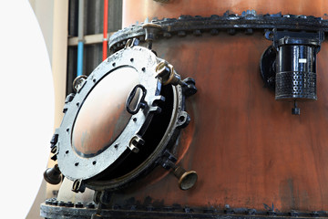 Old brass gin kettles in a distell.