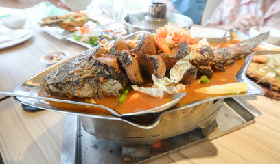 Sour soup made of tamarind paste with fish,Sour curry with deep-fried snake headed fish