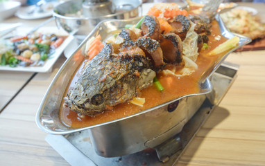 Sour soup made of tamarind paste with fish,Sour curry with deep-fried snake headed fish