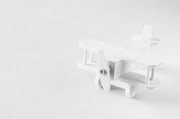 wooden airplane toy over textured wooden background