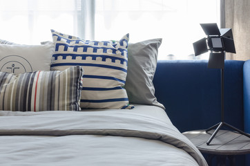 pillows on modern blue bed in bedroom