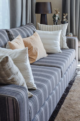 row of pillows on modern grey sofa