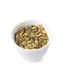 White cup filled with pumpkin seeds