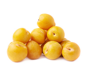 Pile of multiple yellow plums isolated