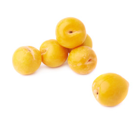 Pile of multiple yellow plums isolated
