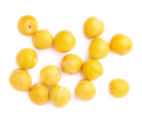 Pile of multiple yellow plums isolated