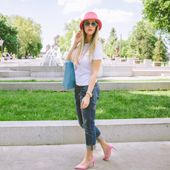 Fashionable girl posing in park