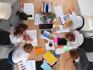 Business people sitting and discussing at business meeting, in