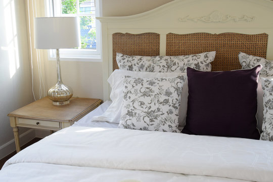 vintage bedroom interior with flower pillows and decorative tabl