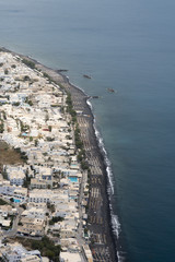 The black volcanic sand beach of Kamari, Santorini, seen from above