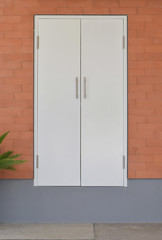 modern white door on brick wall background