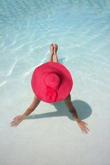 Woman in a pool hat relaxing