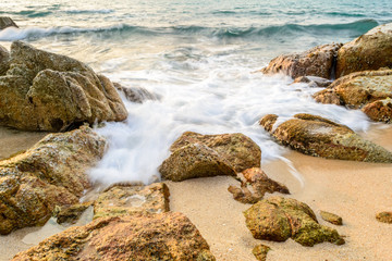 Rocks and sea wave on the beach 
