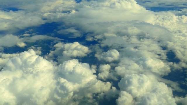 Aerial view of graceful, slow moving clouds far below.

