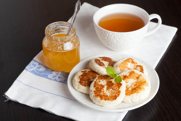 Pancakes, decorated mint, honey and tea, close up