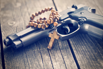 rosary beads and gun