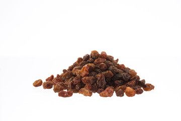 Organic dried raisins in a pile isolated on white