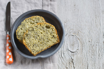 simple cake with poppy seeds on a light wooden background