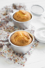 lemon muffins in tins for baking on a light wooden surface