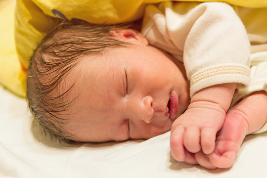 photo of a sleeping newborn baby closeup
