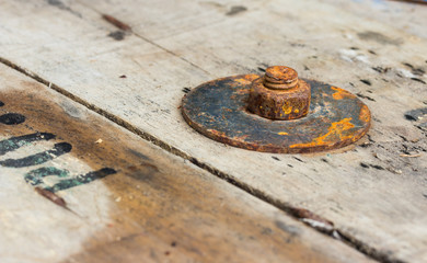rusty nuts on wood background