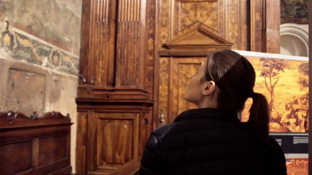 Young woman admire beautiful church in Bergamo, Italy
