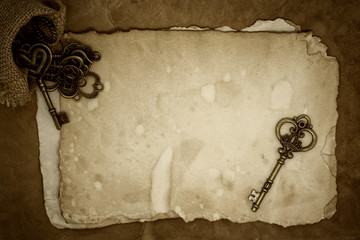 Old keys on old paper background