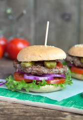 Homemade burgers with green salad, tomato, red onion, beef