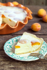 Cake with cottage cheese, apricots and puff pastry on wooden table, selective focus