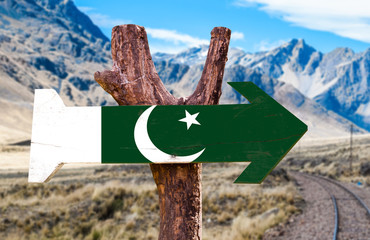 Pakistan Flag wooden sign with desert road background