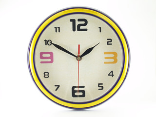 colorful round shaped wall clock with yellow edge isolated on white background, clock hands shown ten minutes to two o'clock