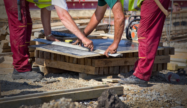 Worker preparing plank for cutting - Powered by Adobe
