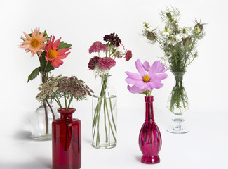 vases of summer flowers isolated on white background